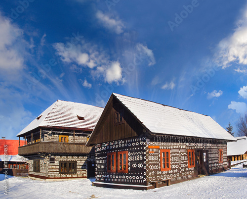 Obraz na płótnie Unique decoration of log houses based on patterns used in traditional embroidery in village of Cicmany village, Slovakia w salonie