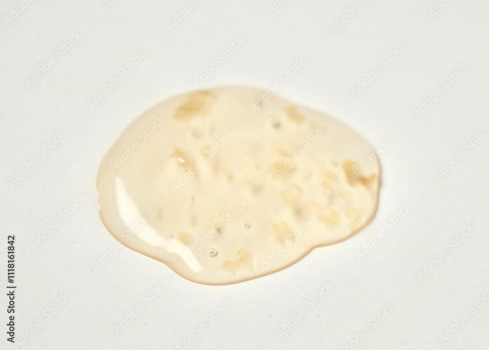 Yellow orange transparent liquid soap body care drop texture isolated on horizontal white background. Yellow orange transparent liquid soap body care drop texture isolated on horizontal white background.