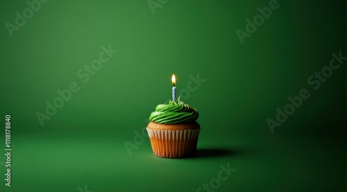 Minimalist plain green background for product photography with just one cupcake