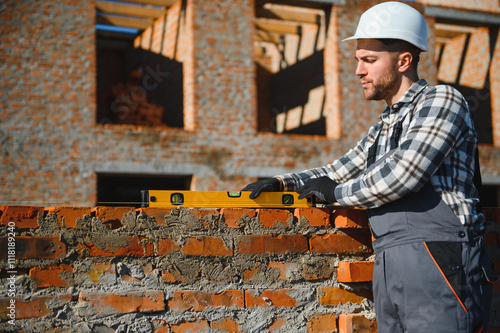 Construction worker in uniform and safety equipment have job on building