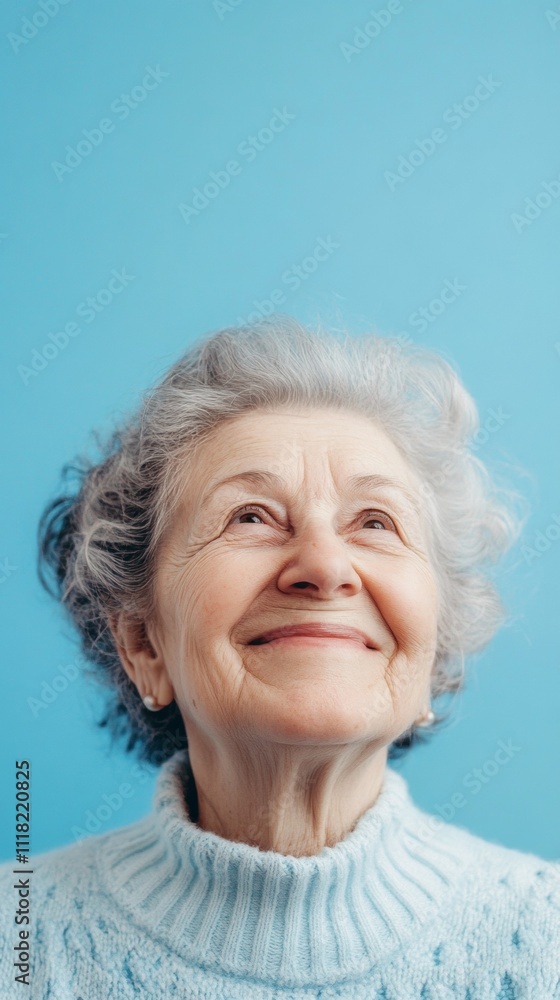 smiling grandmother on blue background with copy space vertically 9:16 smiling grandmother on blue background with copy space vertically 9:16