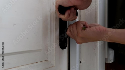 Woman open door lock with a key, open door and leaving out stylish light apartments