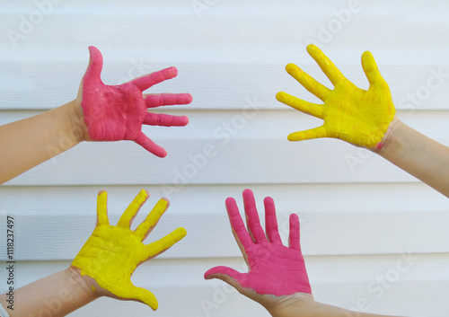 hildren's hands stained with various colors on a white background the concept of childhood, play and friendship, summer holidays in a children's team

 photo