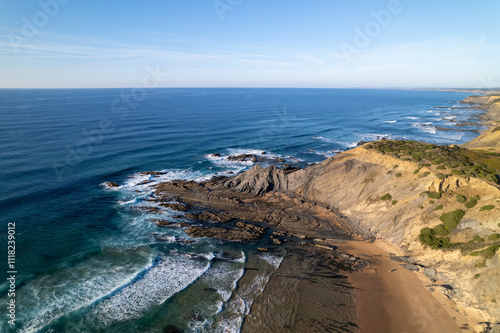 Amazing seascape view of the cliffs at Praia de Amoreira (Amoreira beach), located in Aljezur, Costa Vicentina, Algarve, Portugal. Horizon atlantic blue ocean view with cliffs