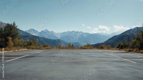 A scenic empty parking lot in the mountains, offering a panoramic view of the surrounding peaks