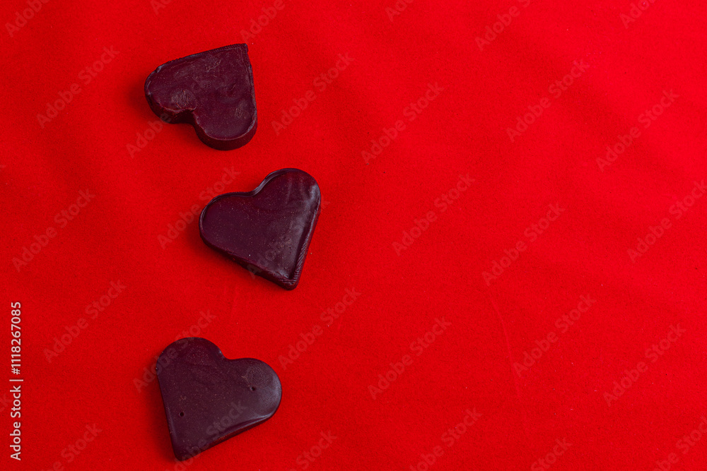 Fototapeta premium Valentine's Day celebration composition, chocolate hearts on a red background