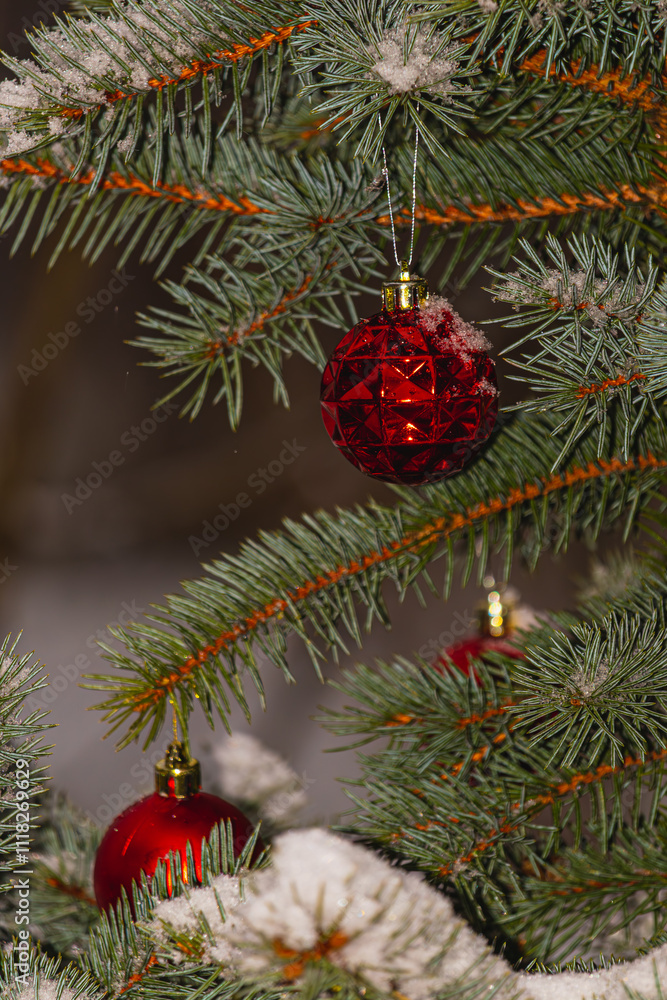 Christmas tree is adorned with vibrant red ornaments and a soft layer of snow Christmas tree is adorned with vibrant red ornaments and a soft layer of snow