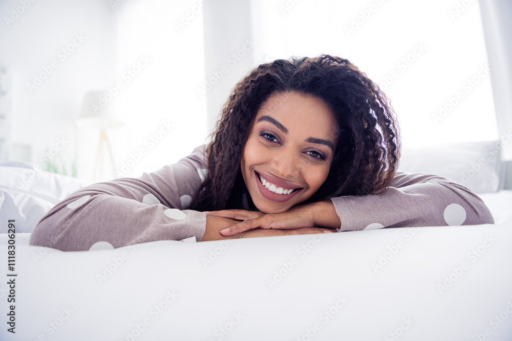 Young woman enjoying a relaxing morning in bed, smiling happily in natural light Young woman enjoying a relaxing morning in bed, smiling happily in natural light