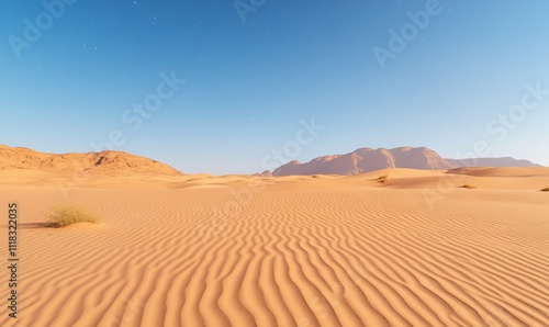 Serene desert landscape with rippling sand dunes under a clear sky.