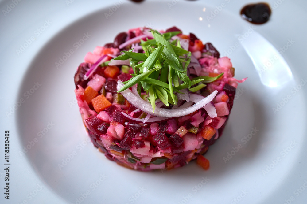 A beautiful white plate with a vibrant salad of beets, carrots, and onions A beautiful white plate with a vibrant salad of beets, carrots, and onions