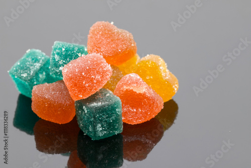 Colorful Sugary Jelly Candies Piled on Reflective Gray Surface
