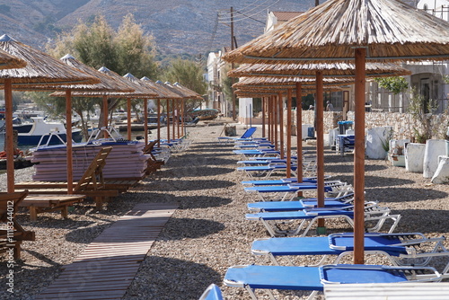 sunbeds and sunshades on the beach of Pedi , Greece photo