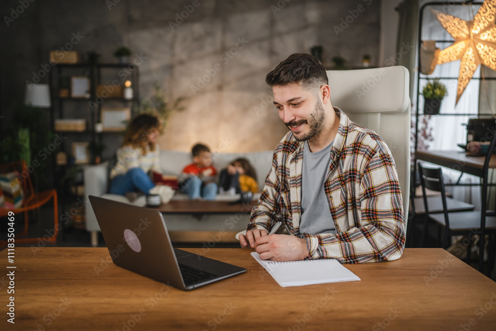 dad work from home take a notes in a notebook from laptop dad work from home take a notes in a notebook from laptop