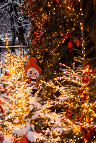 Decorated Christmas trees in the evening at a snowy street in Kaliningrad.
