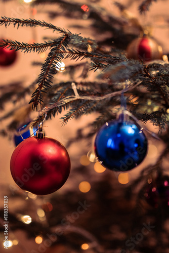 Red and blue balloons handing on the Christmas tree.