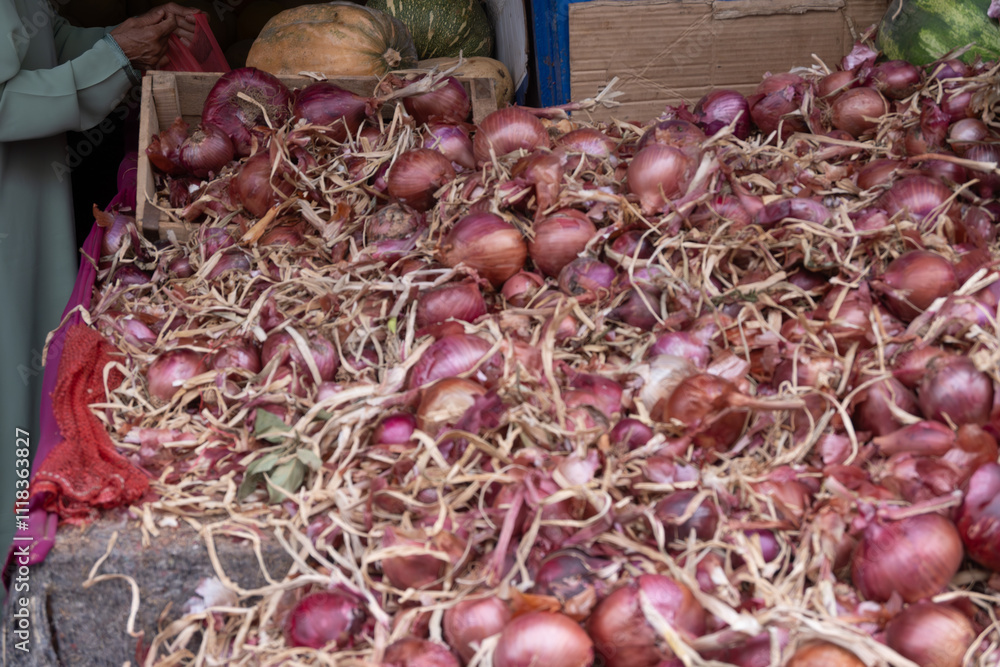Red onion stack on straw with wooden crates and produce Red onion stack on straw with wooden crates and produce