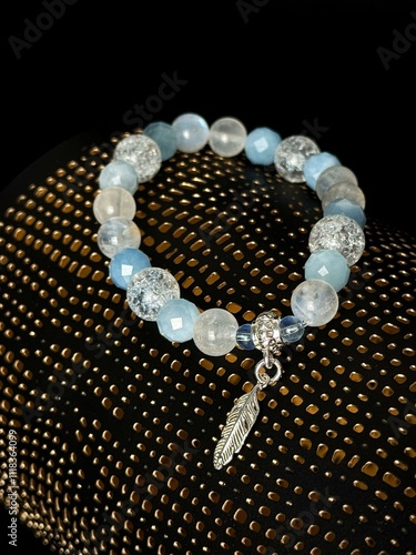 bracelet made of expensive natural stone with silver inserts and a pendant with runes