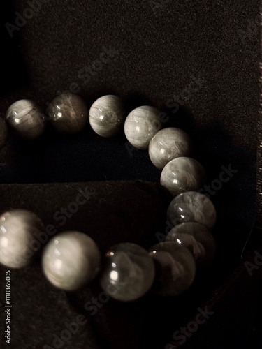bracelet made of expensive natural stone with silver inserts and a pendant with runes