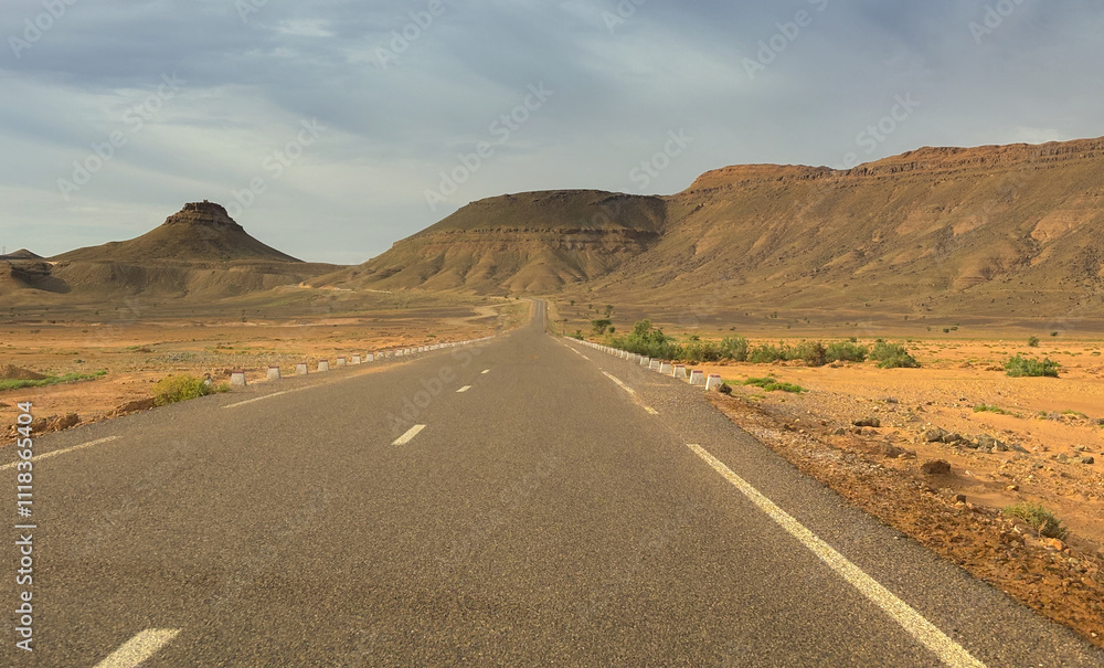 Long road through the Moroccan desert along the Atlas Mountains Long road through the Moroccan desert along the Atlas Mountains