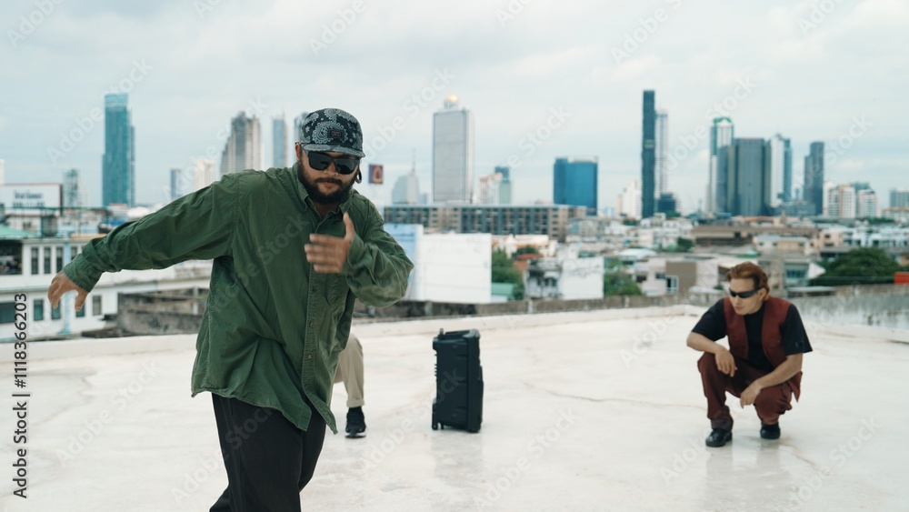 Obraz premium Professional break dance team practice B-boy dance while multicultural friends at rooftop. Young modern dancing group doing hip hop movement. Style,fashion,action. Outdoor sport 2024. Hiphop.