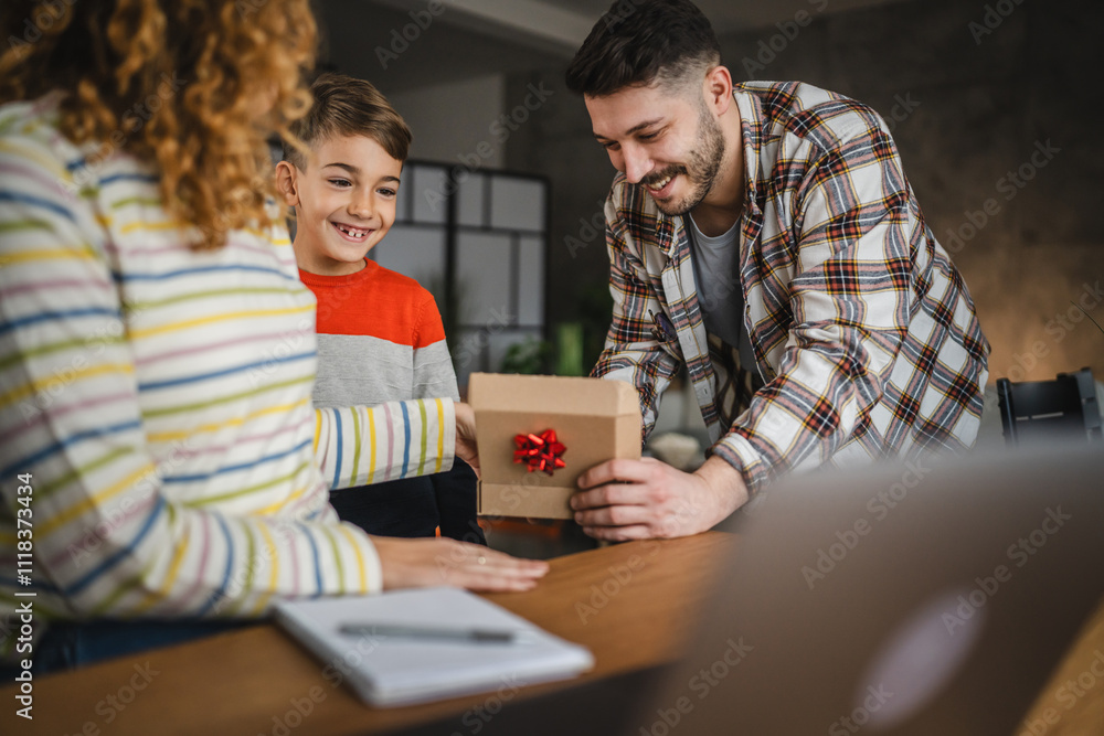 Mother and father surprise son with gift at home Mother and father surprise son with gift at home