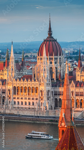 Photography The photo captures the Hungarian Parliament Building in Budapest during sunset, beautifully reflecting the warm sunlight on its Neo-Gothic architecture along the Danube River