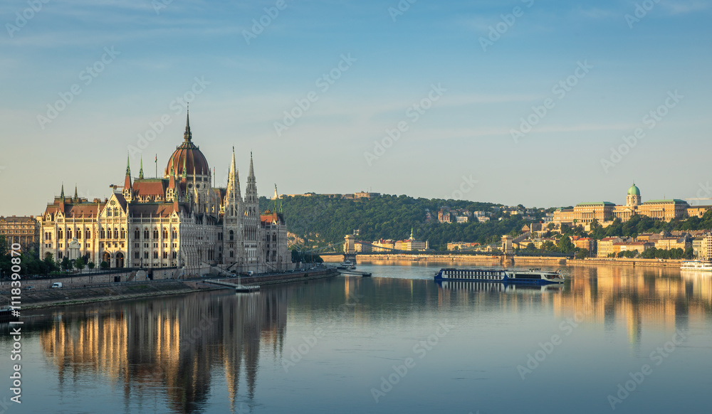 Morning panorama of Budapest with the Hungarian Parliament Building, the Danube River, and the Buda Castle in the distance, creating a serene and picturesque scene. Morning panorama of Budapest with the Hungarian Parliament Building, the Danube River, and the Buda Castle in the distance, creating a serene and picturesque scene.