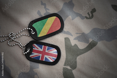 army blank, dog tag with national flag of republic of the congo and great britain on the khaki texture background. military concept. photo