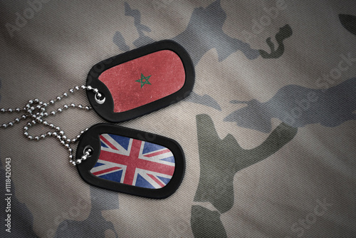 army blank, dog tag with national flag of morocco and great britain on the khaki texture background. military concept. photo