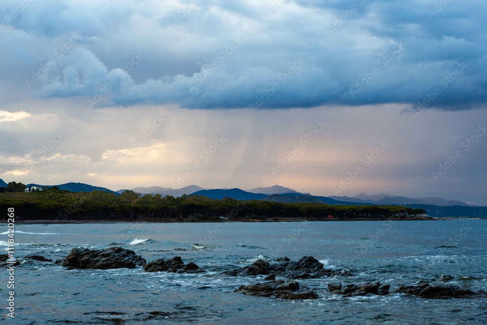 Mediterranean coast with pine forest and mountain range at background on cloudy day. Sardinia, Italy. Mediterranean coast with pine forest and mountain range at background on cloudy day. Sardinia, Italy.