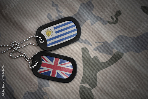 army blank, dog tag with national flag of uruguay and great britain on the khaki texture background. military concept. photo