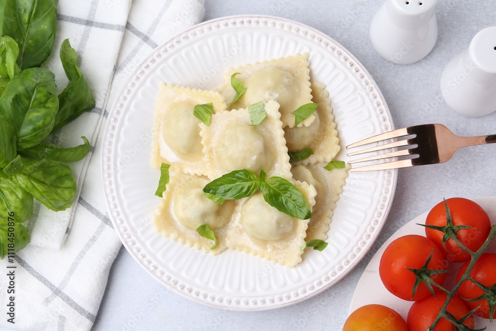 Delicious ravioli with cheese and basil served on light table, flat lay Delicious ravioli with cheese and basil served on light table, flat lay