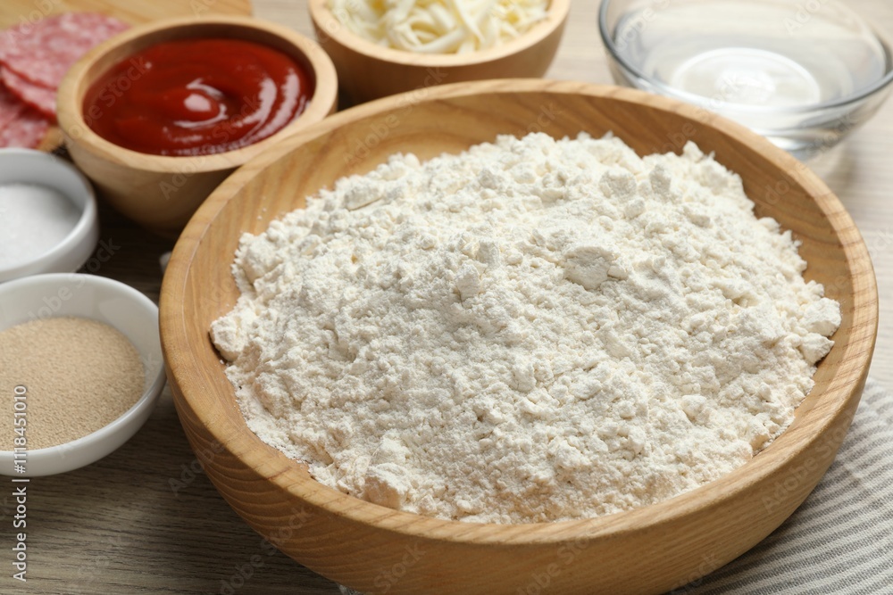 Making calzone pizza. Different ingredients on wooden table, closeup Making calzone pizza. Different ingredients on wooden table, closeup