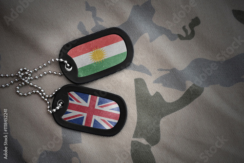 army blank, dog tag with national flag of kurdistan and great britain on the khaki texture background. military concept. photo