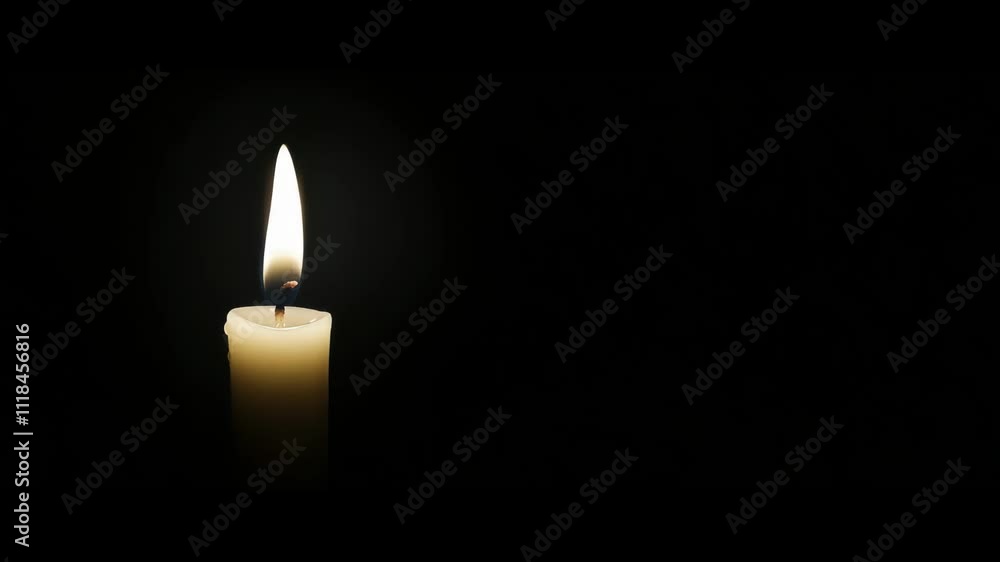 White burning candle on black background White burning candle on black background