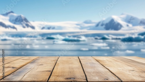 A wooden table in front of a serene snowy landscape and icy waters.