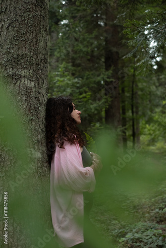 Woman holding green leaf in forest. Nature harmony and mental wellness scene
