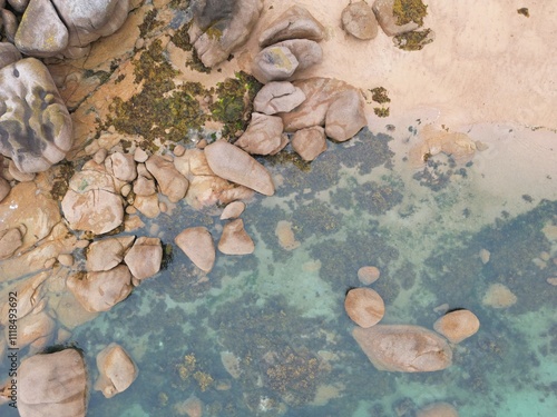 Vertical aerial view of a coastline with large blocks of pink granite and sand - Vue verticale aérienne d'une côte avec des gros blocs de granit rose et du sable photo