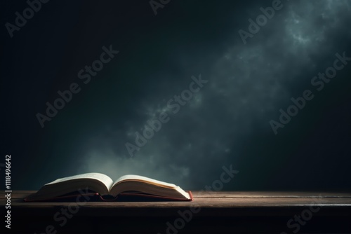 Open book lying on wooden table with smoke in background