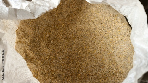 white open top bag with dry mixed feed for farm poultry, combined nutrition from ground grains and food additives for keeping farm animals