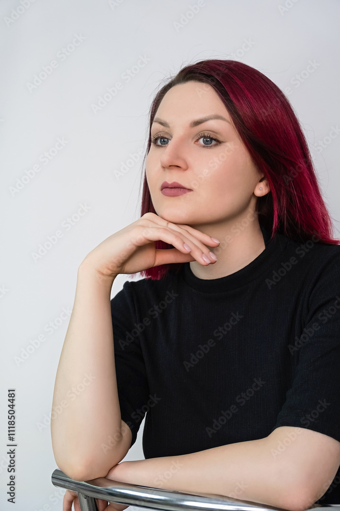 Portrait of a young woman with vibrant cherry red hair on a light background. Closeup. Portrait of a young woman with vibrant cherry red hair on a light background. Closeup.