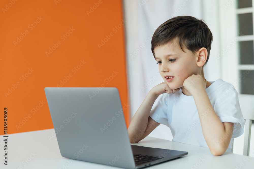 Boy Studying Playing On Laptop Online At Table Boy Studying Playing On Laptop Online At Table