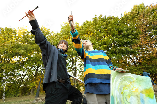 two young and innovative female artists conducting an outdoor painting lesson