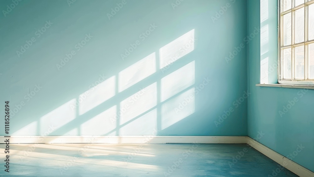 A tranquil and minimalist empty room with blue walls and sunlight casting geometric shadows through a large window, creating a serene and peaceful atmosphere. A tranquil and minimalist empty room with blue walls and sunlight casting geometric shadows through a large window, creating a serene and peaceful atmosphere.