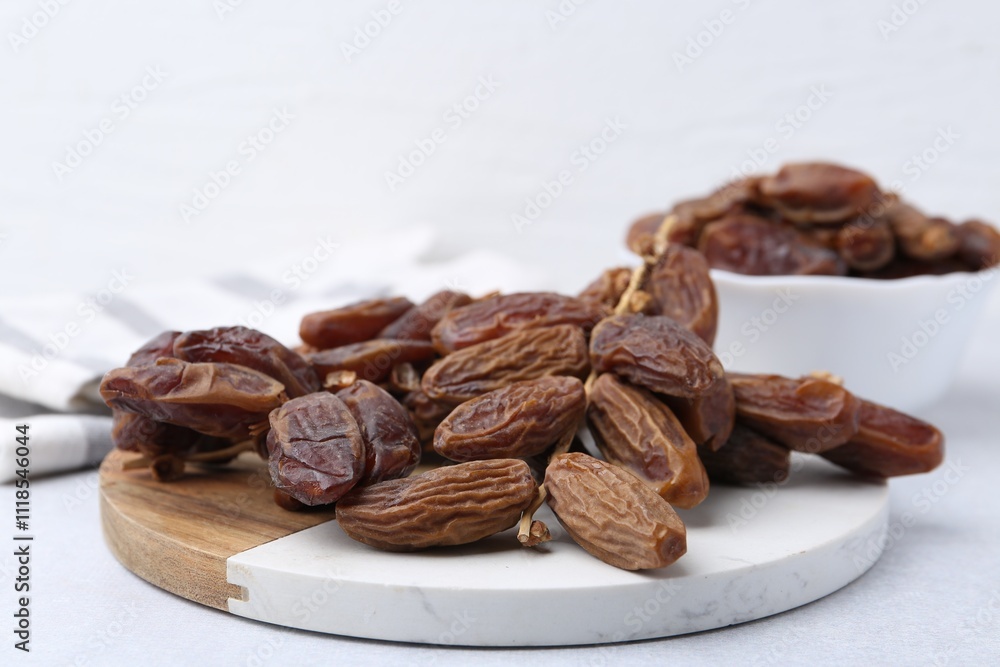 Tasty dried dates on light table, closeup Tasty dried dates on light table, closeup