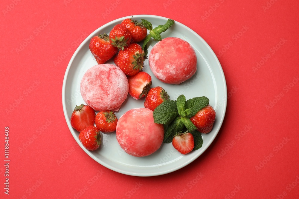 Delicious mochi, strawberries and mint on red background, top view Delicious mochi, strawberries and mint on red background, top view