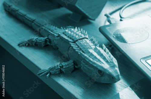 Object printed on 3D printer. Abstract toy green crocodile with many different detailed parts on table and created on 3d printer. Concept FDM 3D Printing. Additive modern new progressive technology photo