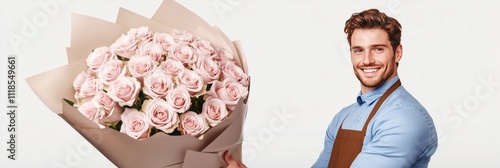 Young smilling man in blue shirts and brown aproon holdihg a big bouquet of pink roses  photo