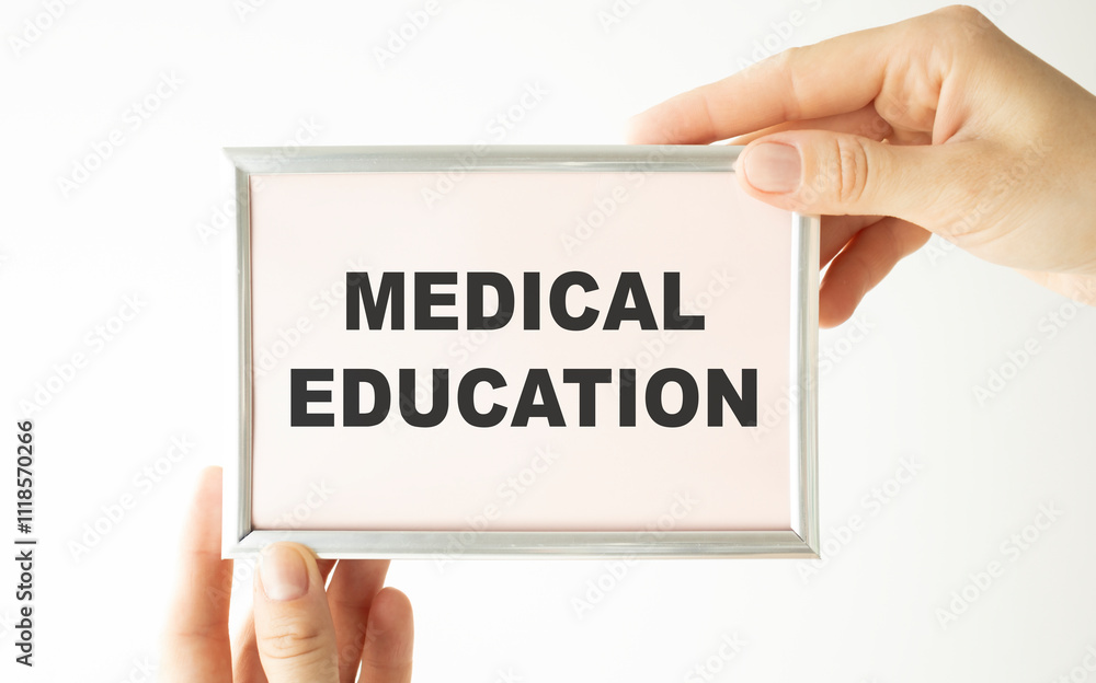 Hands holding clipboard with text medical education on a sheet of paper on a white background Hands holding clipboard with text medical education on a sheet of paper on a white background