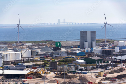 Wind turbines in Copenhagen port with the Oresund bridge in background, Denmark, sustainable renewable electricity concept photo